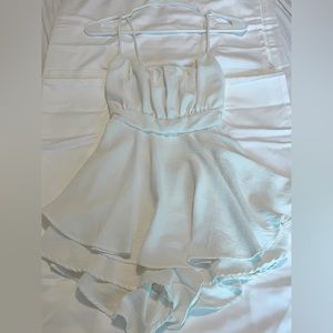 white romper with a open back, super cute tie bow! WORN ONCE BASICALLY BRAND NEW